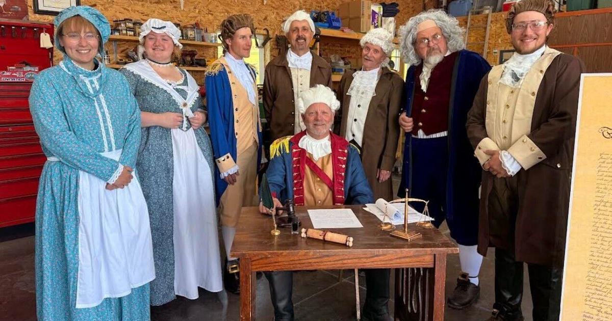 Local actors recreate the signing of the Declaration of Independence