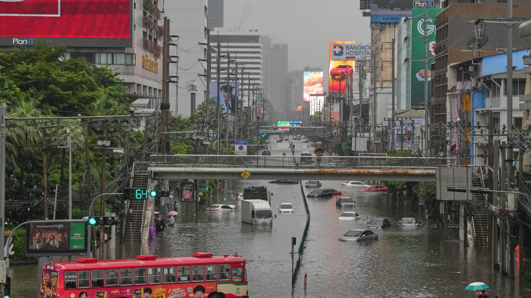 Heavy rain and flooding in Bangkok disrupts traffic and prompts evacuations