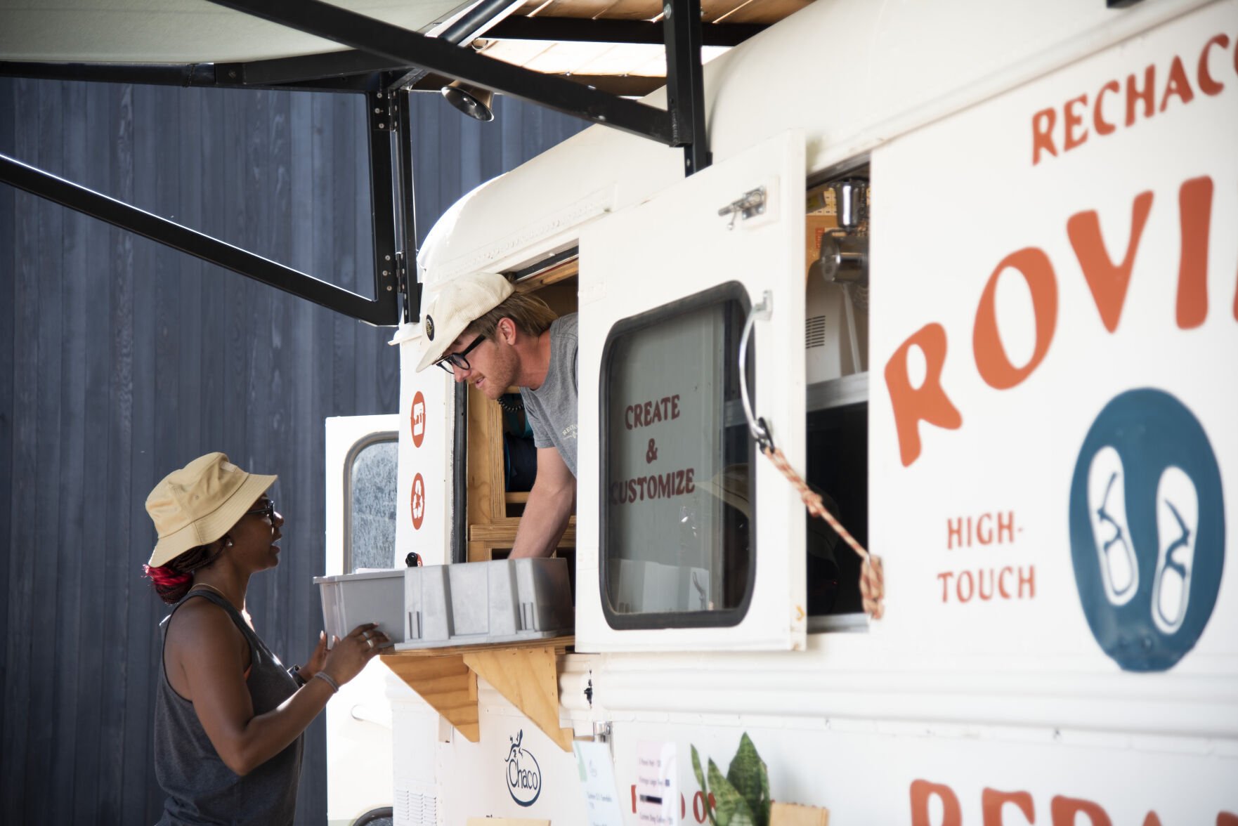 Chaco roving repairs bus stops in Bozeman during summer long tour