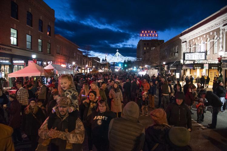 Santa lights up spiders at snowfree Christmas Stroll in downtown