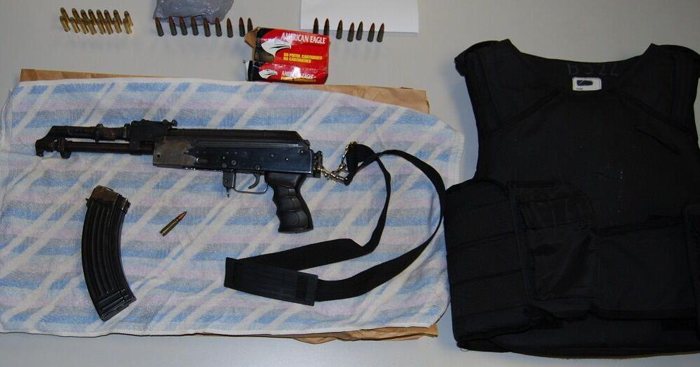 Man turns himself in after loaded assault rifle seized in raid