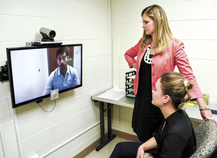 Counselors demonstrating telehealth counseling in the Brenham facility