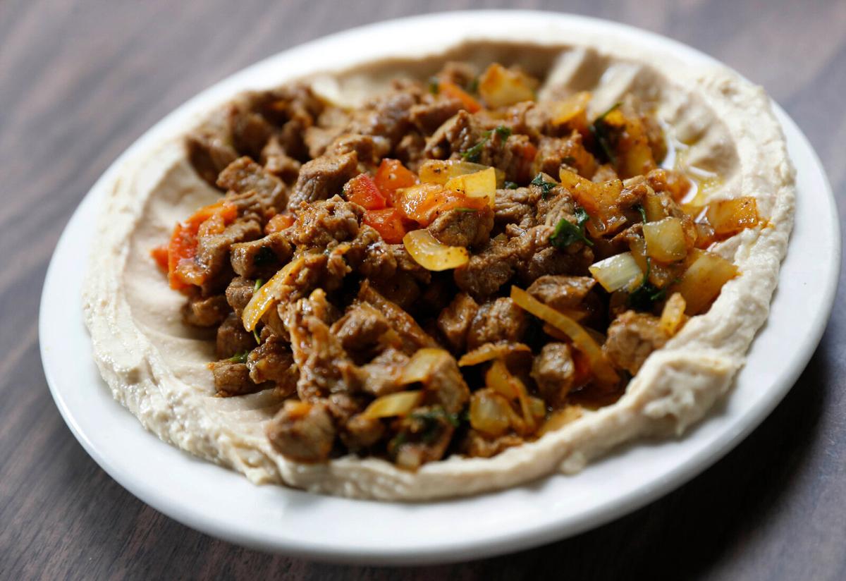 Lamb ghallaba over hummus at Crave King
