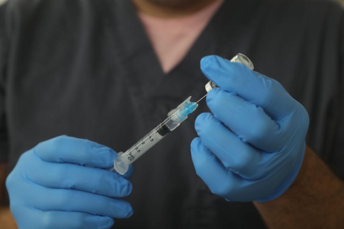 Pharmacist Craig Rudzinski prepares a covid-19 vaccine shot (copy)