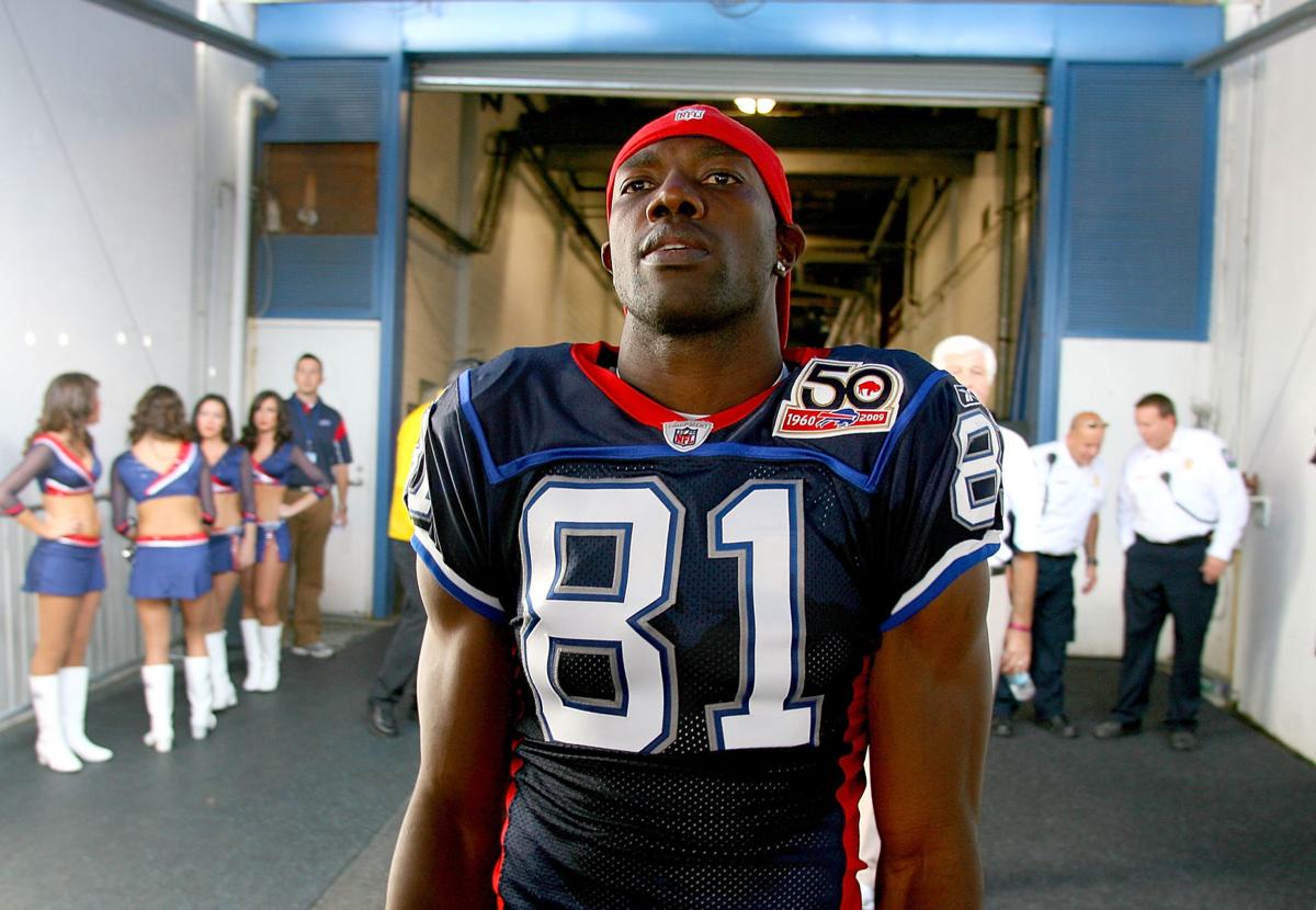 Buffalo Bills widereciever Terrell Owens is all smiles as he models the throwback  jersey for the 50th season celebration durring Thursday nights practice at  St. John Fisher College in Rochester, NY (Credit