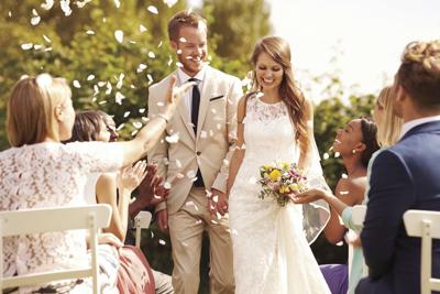 Guests Throwing Confetti Over Bride And Groom At Wedding