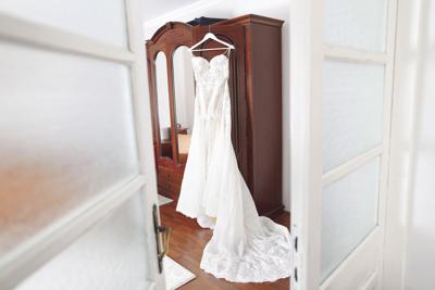 Beautiful wedding dress hanging on door