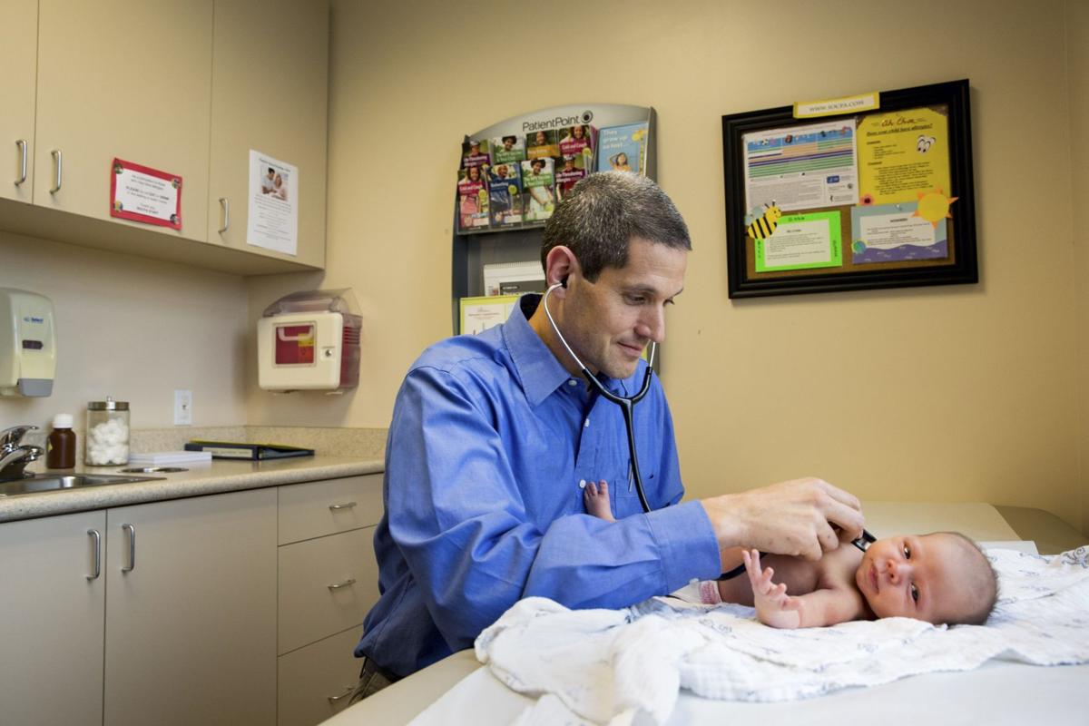 Eric Ball, a pediatrician in southern Orange County, who is treating unvaccinated girls who got sick with the measles last week, examines Joyelle Johnson.