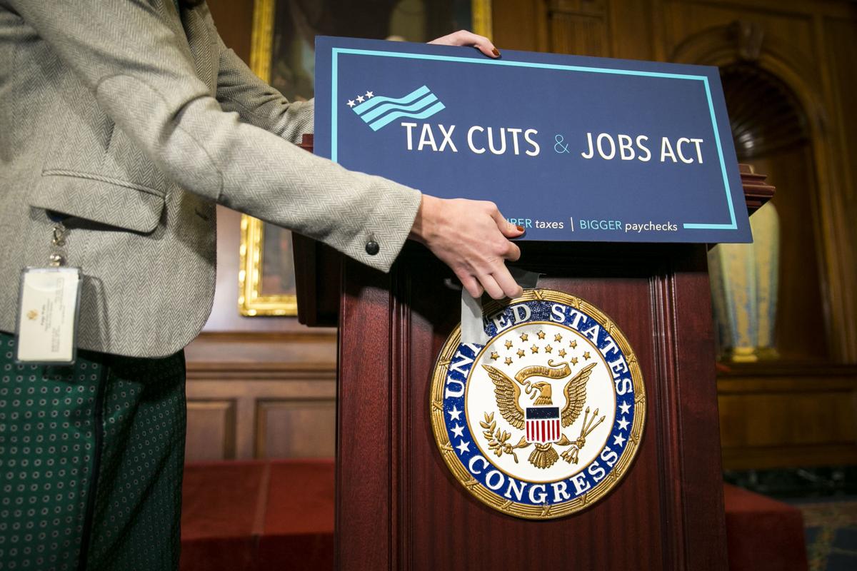 A sign is applied onto a lectern before a news conference following the House passing the Republican-led tax reform bill, on Capitol Hill in Washington.
