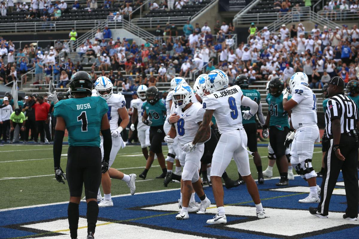 B Bull's wide receiver Dominic Johnson (9) celebrates UB running back Kevin Marks, Jr. (5) touchdown.
