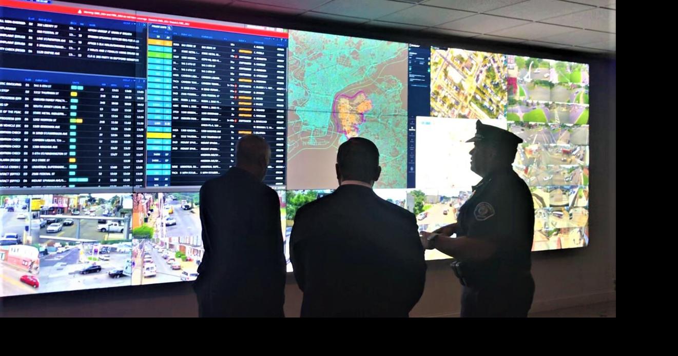 Camden Mayor Victor Carstarphen, left, and N.J. Assemblyman William Moen, center, listen to county Police Chief Gabriel Rodriguez explain monitors during a tour July 31, 2023, of the Real Time Tactical Information Center on Federal Street. Displays various