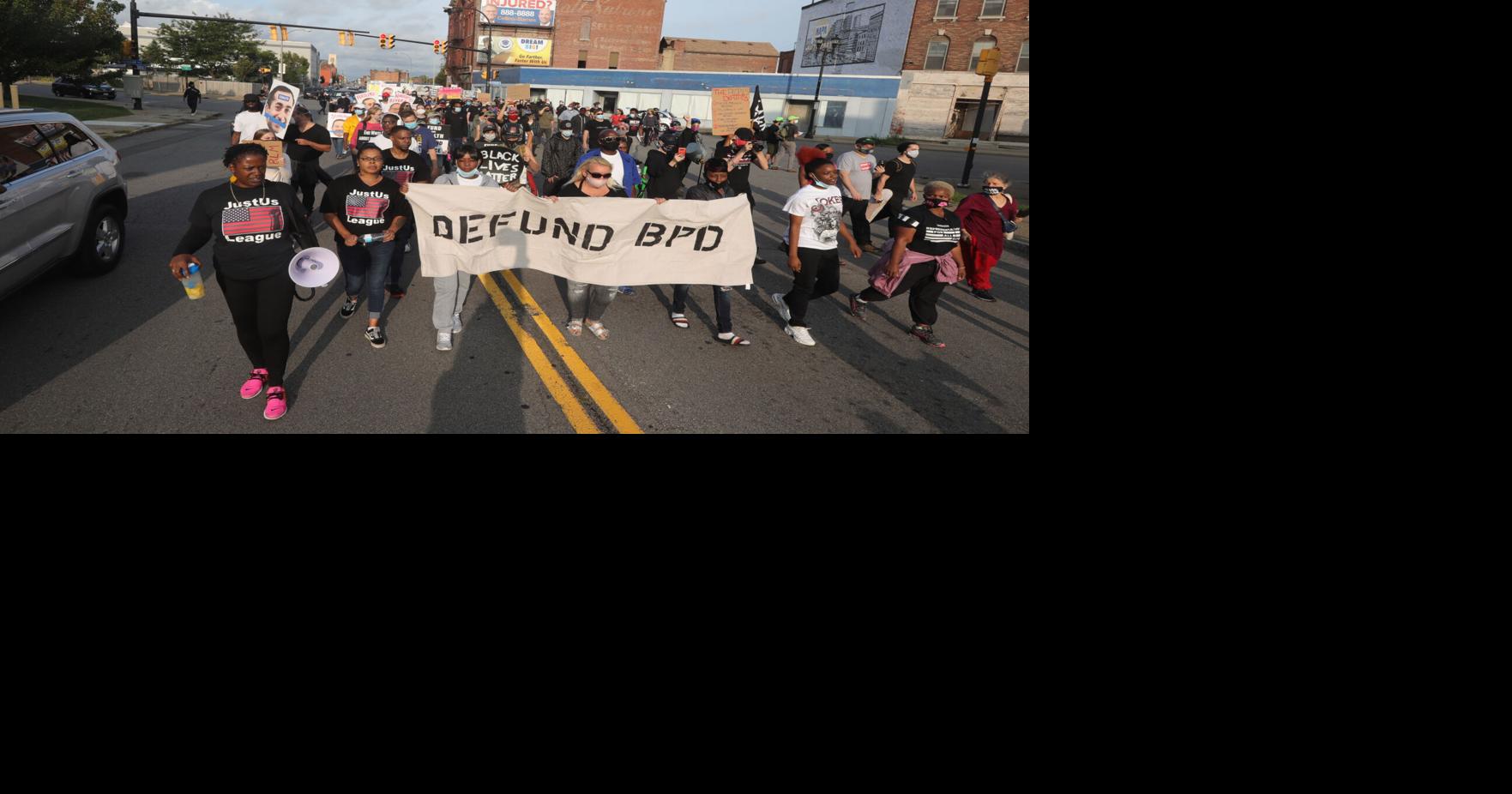 Mentally ill man shot by cops faces charges as dozens march through ...