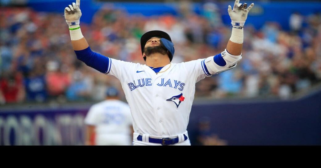 Toronto Blue Jays' Bo Bichette, right, shares a laugh with