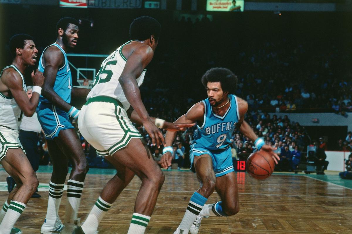 Bob McAdoo of the New York Knicks walks on the court against the News  Photo - Getty Images