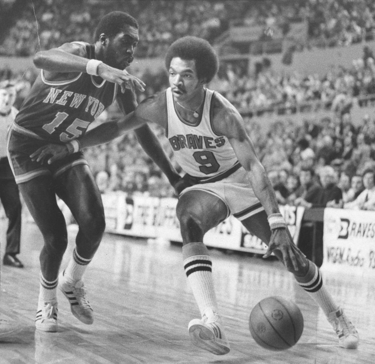 Bob McAdoo of the Buffalo Braves battles for position with Elvin