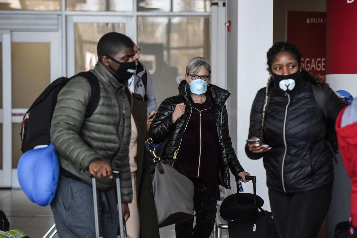 People wear masks at JFK Airport in New York, Feb. 27, 2020. (Stephanie Keith/The New York Times)