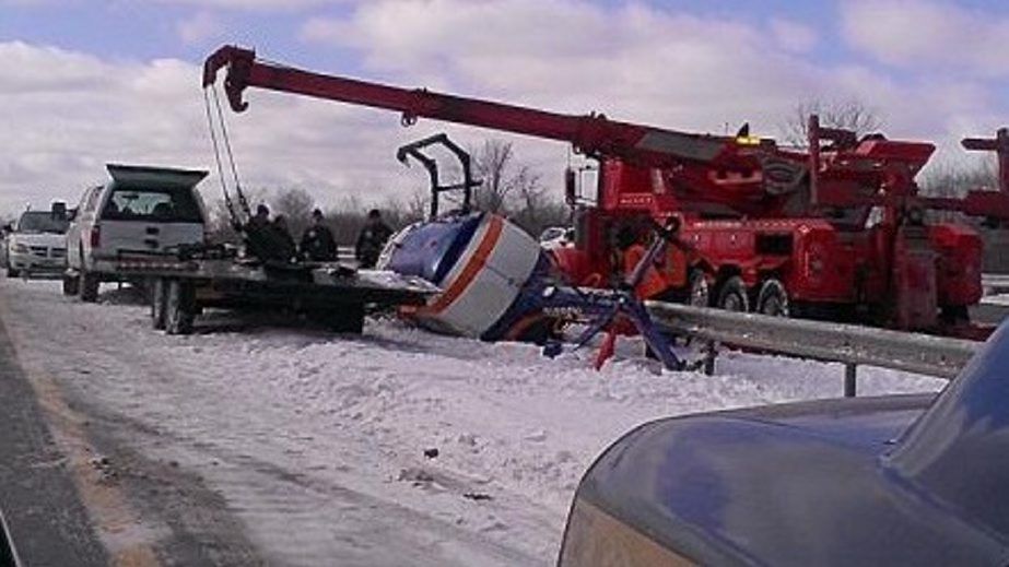 Tractor trailer hauling helicopter rolls over on Thruway at Pembroke