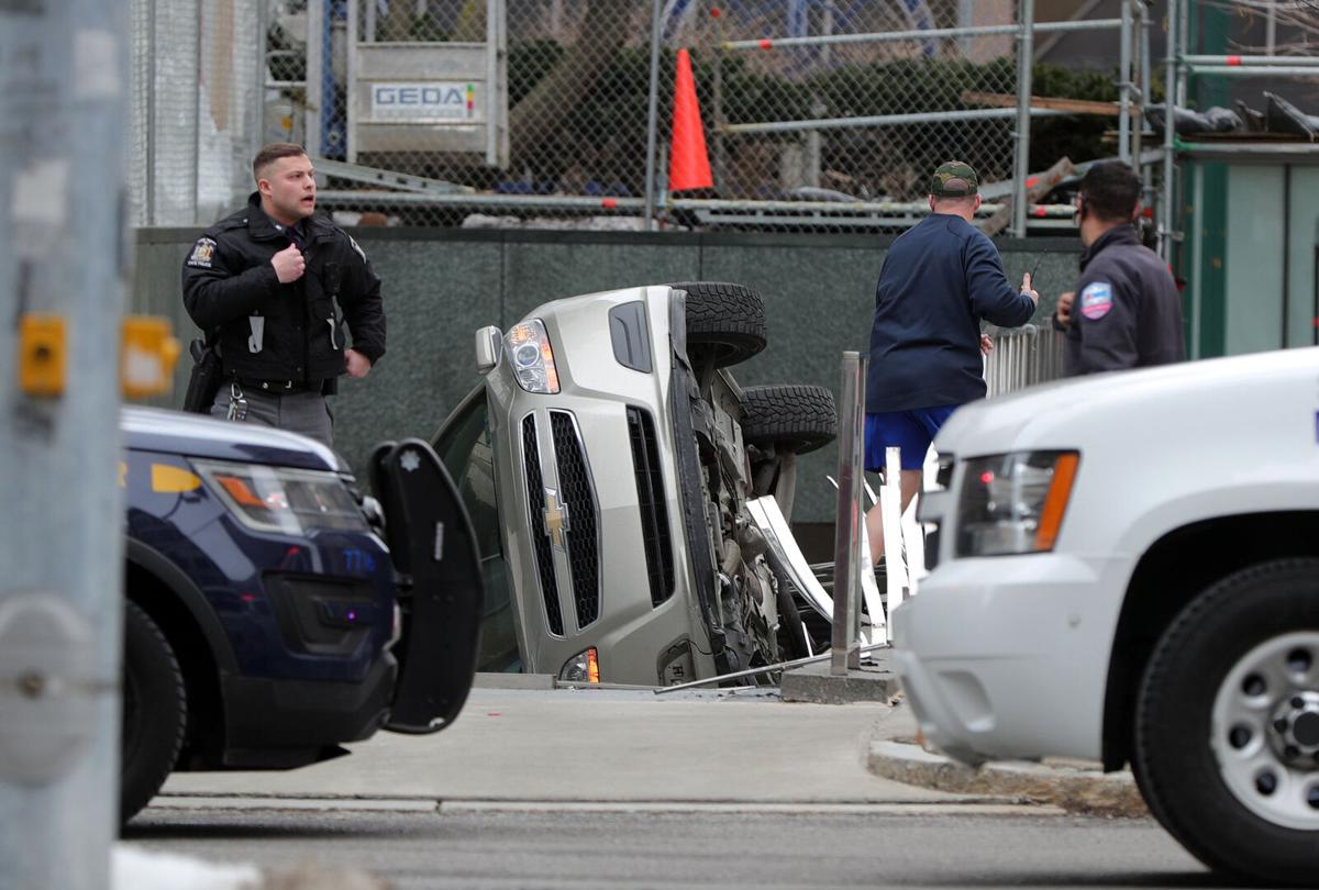 Car on its side following chase