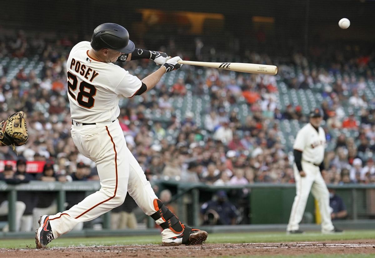 Buster Posey of the San Francisco Giants hits a three-run home run against the Arizona Diamondbacks in the bottom of the first inning at Oracle Park on June 16, 2021 in San Francisco, California.