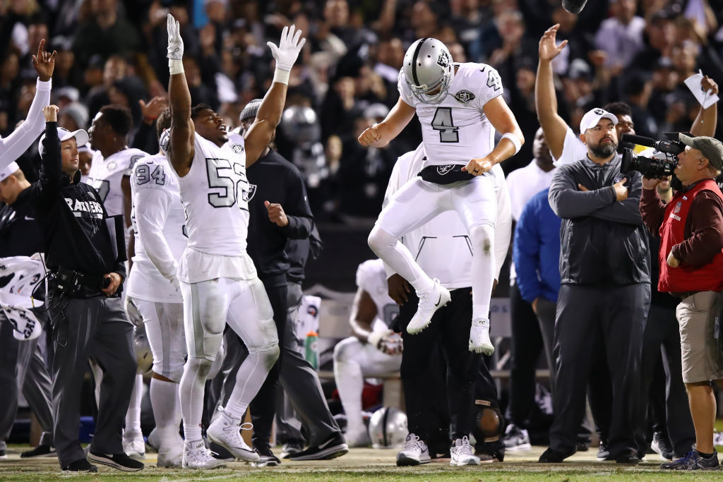 Oakland Raiders quarterback Derek Carr (4) celebrates with defensive end  Khalil Mack (52) during the second half of an NFL football game against the  Buffalo Bills in Oakland, Calif., Sunday, Dec. …