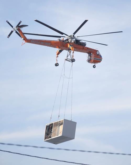 Powerful crane helicopter lifts 44 air cooling units onto SolarCity