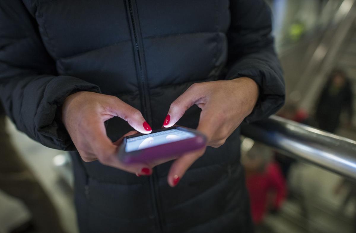 A commuter on her phone at Penn Station in New York.