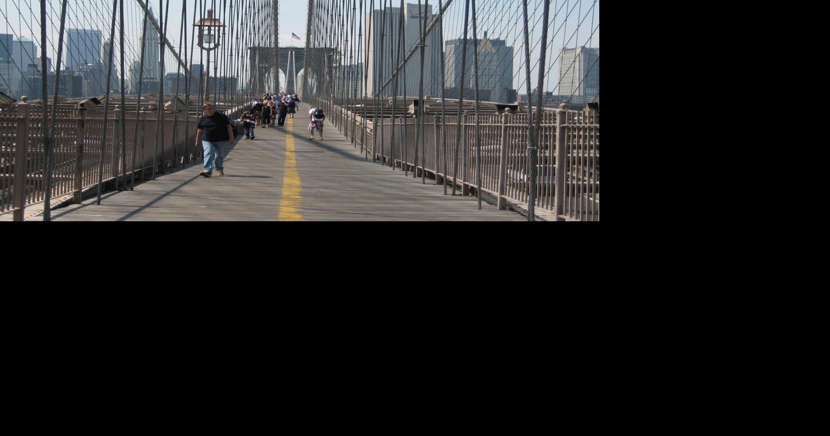 Walking across Brooklyn Bridge.