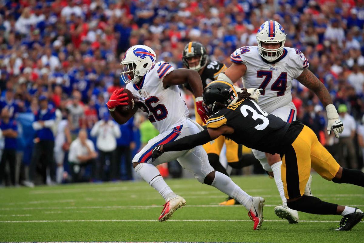 Buffalo Bills quarterback Josh Allen (17) hands off the ball to running  back Devin Singletary (26) during the first quarterof an NFL division round  football game, Sunday, Jan. 22, 2023, in Orchard
