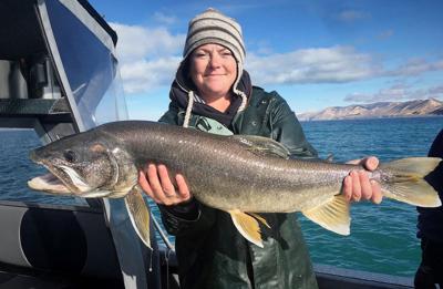 scott_tolentino_10-2019_DWR_technician_Emily_Wright_shows_lake_trout_caught_and_released_at_Bear_Lake_during_gillnet_survey