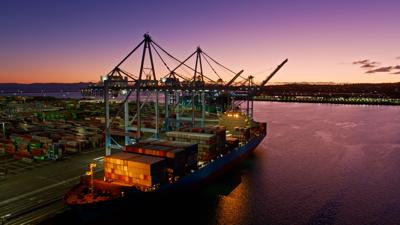 Aerial shot of a massive ship in the Port of Los Angeles at twilight