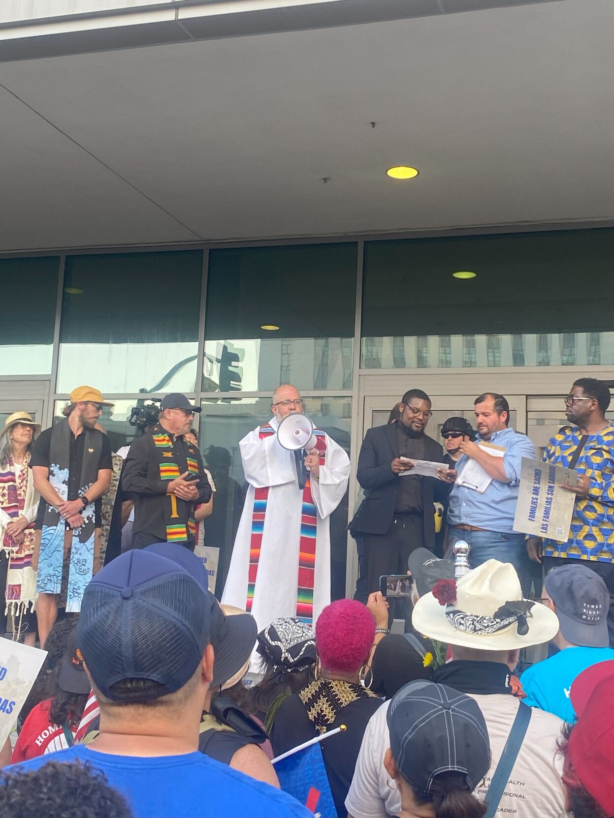 Fr. Brendan Busse S.J. of Dolores Mission Church speaks at the federal building.jpg