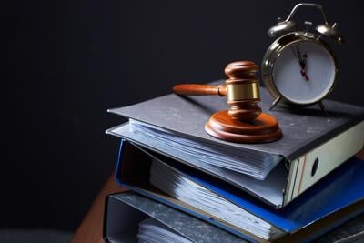 Close-up of gavel and stacks of files