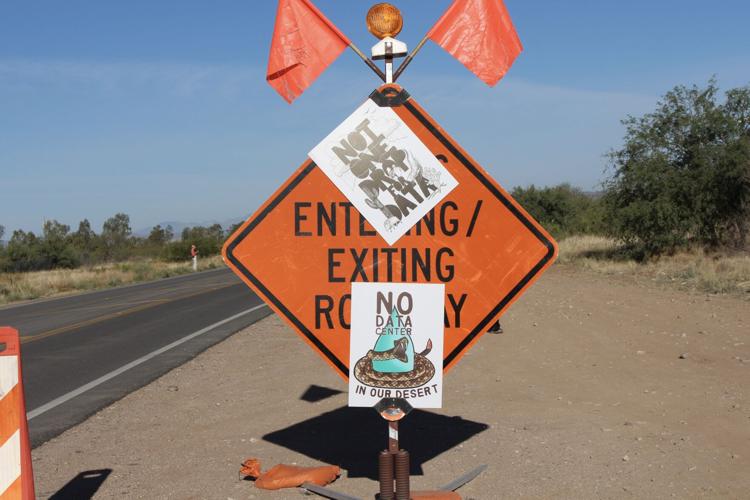 Posters on construction sign.JPG