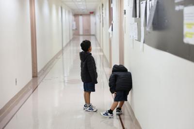 Children wait outside of an immigration court