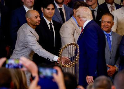 U.S. President Donald Trump greets Los Angeles Dodgers shortstop Mookie Betts