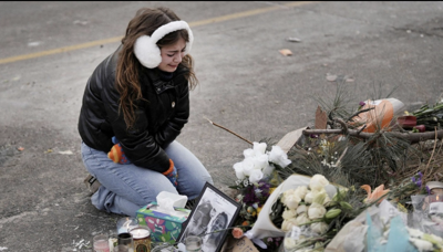 A young woman visits a makeshift memorial in Minneapolis Jan. 25