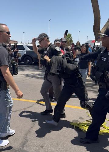 Police take protester away .jpg
