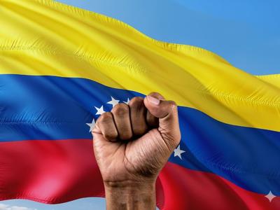 Venezuela flag and hand in fist