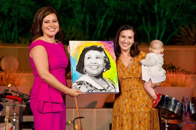 7) ABC Executive Director Vanessa Aramayo (left) hands over a portrait of Gloria Molina to her daughter Valentina Martinez. (Photo courtesy of ABC)