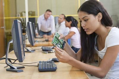 Student at computer using microcontroller board