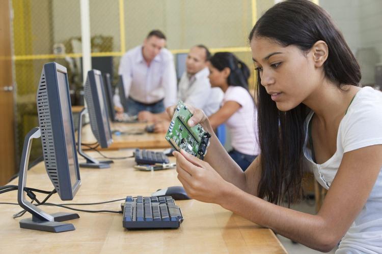 Student at computer using microcontroller board