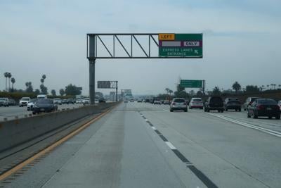 View Out Front of Vehicle on Busy Expressway