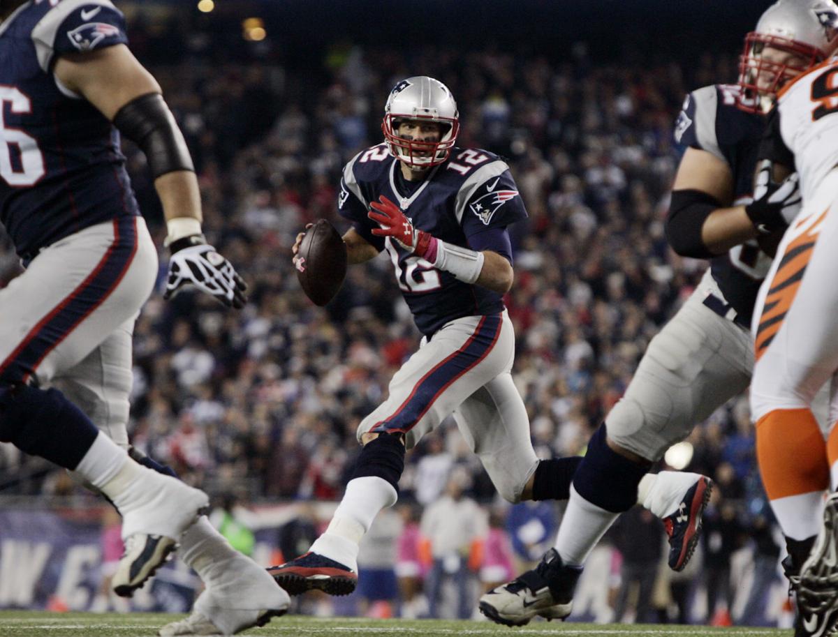 New England Patriots quarterback Tom Brady rolls to his right and looks for an open receiver against the Cincinnati Bengals on Sunday evening.