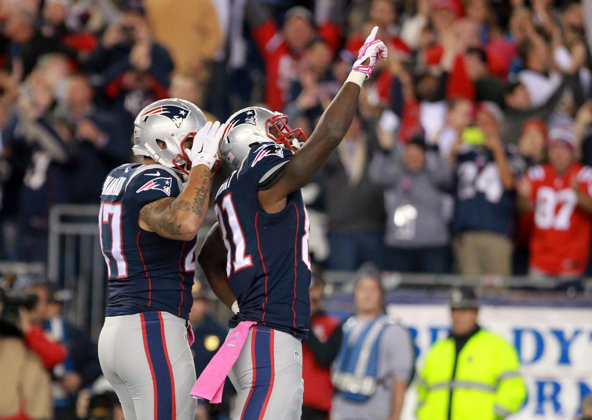 New England Patriots tight end Tim Wright (81) celebrates his first quarter touchdown reception with teammate Michael Hoomanawanui (47) on Sunday evening.