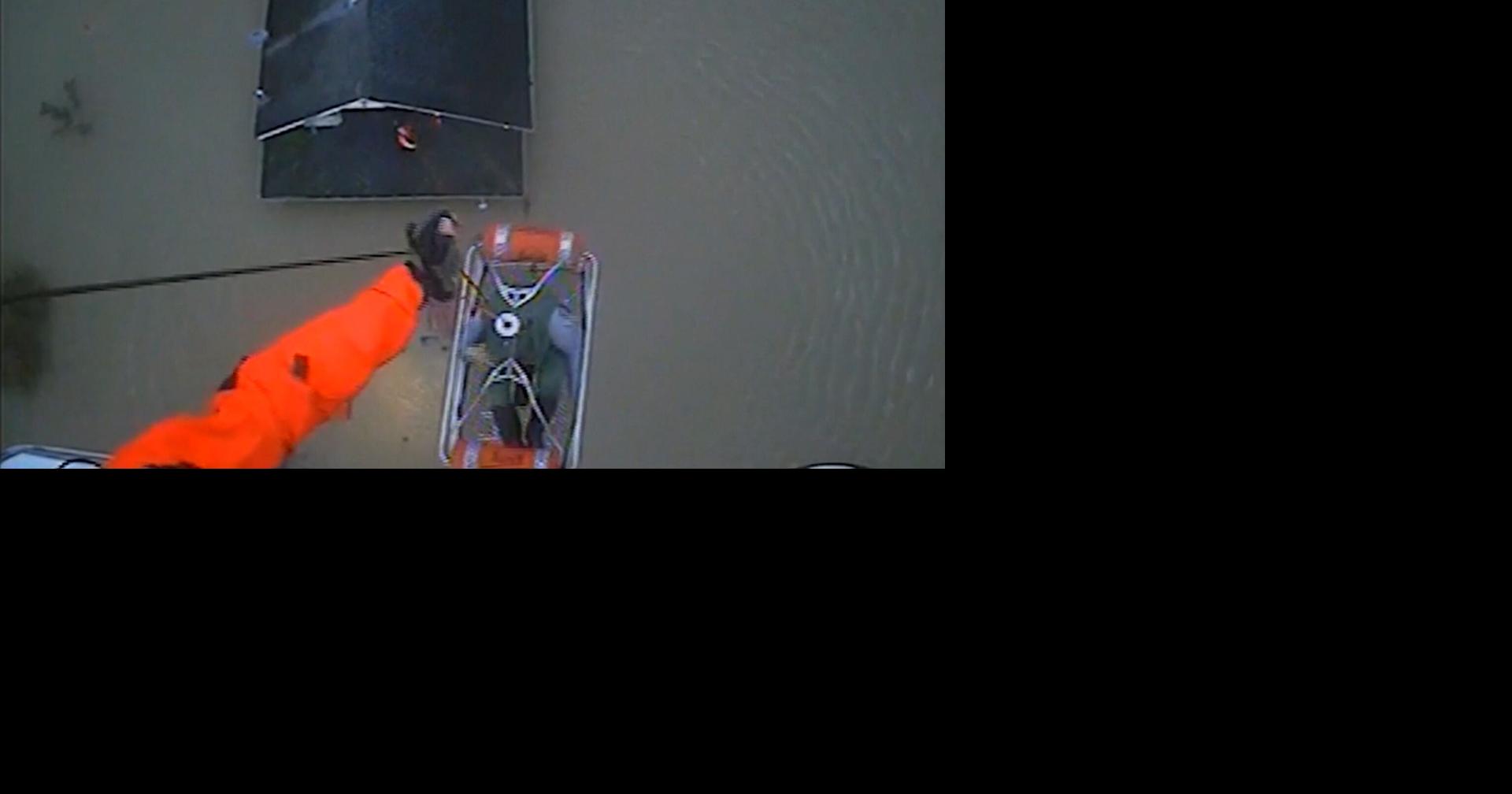 Coast Guard helicopter plucks 2 people from roof of submerged ...