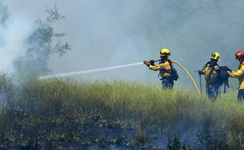 One-acre brush fire burns Wednesday afternoon alongside El Prado Road in Chino