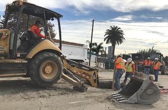 Crews dig a hole on Pipeline Avenue