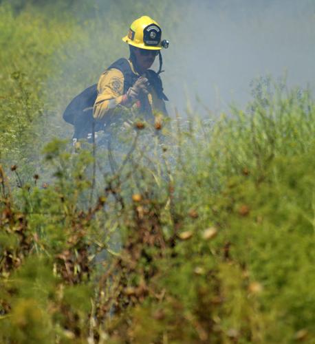One-acre brush fire burns Wednesday afternoon alongside El Prado Road in Chino