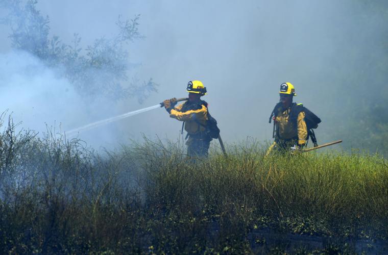 One-acre brush fire burns Wednesday afternoon alongside El Prado Road in Chino