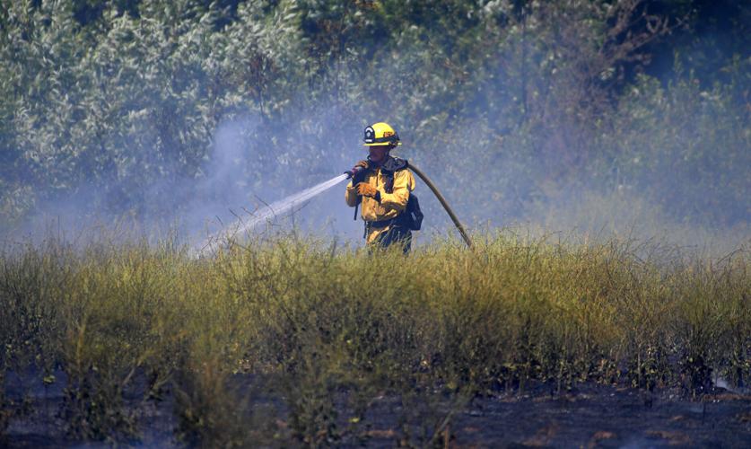 One-acre brush fire burns Wednesday afternoon alongside El Prado Road in Chino